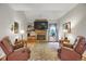 Inviting living room with a stone fireplace, vaulted ceiling, and comfortable seating at 6112 Alkire Ct, Arvada, CO 80004