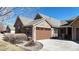 Attractive home featuring a stone and siding exterior, well-maintained landscaping, and a two car garage at 2238 Calais Dr # B, Longmont, CO 80504