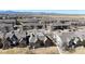 Wide aerial view of a sprawling residential neighborhood with picturesque mountain views in the distance at 2238 Calais Dr # B, Longmont, CO 80504