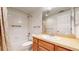 Neutral bathroom featuring a vanity with wood cabinets, a tub/shower combination, and tile flooring at 2238 Calais Dr # B, Longmont, CO 80504