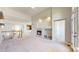 Open living room featuring a fireplace, high ceilings, and abundant natural light at 2238 Calais Dr # B, Longmont, CO 80504