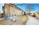 Side view of home featuring stone accents, tan siding, and a well-maintained walkway at 2238 Calais Dr # B, Longmont, CO 80504