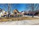 Charming home showcasing a stone facade, shutters, manicured landscaping, and a two-car garage at 2238 Calais Dr # B, Longmont, CO 80504