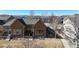 Charming home exterior featuring stone accents, neutral paint, well-maintained lawn, and mountain views in the background at 2238 Calais Dr # B, Longmont, CO 80504