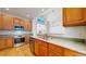 Bright kitchen with stainless steel appliances, wood cabinets, and a large window above the sink at 2238 Calais Dr # B, Longmont, CO 80504
