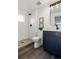 Updated bathroom featuring subway tile shower, dark blue vanity, and modern fixtures at 4511 Tabor St, Wheat Ridge, CO 80033