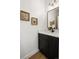 Modern half bathroom featuring dark vanity and brushed gold hardware at 4511 Tabor St, Wheat Ridge, CO 80033
