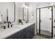 Modern bathroom featuring a double vanity, tiled shower, and contemporary fixtures at 4511 Tabor St, Wheat Ridge, CO 80033