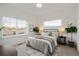 Well-lit bedroom featuring large windows, a cozy bed, and stylish side tables at 4511 Tabor St, Wheat Ridge, CO 80033