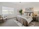 Comfortable bedroom with large window, stylish decor, and cozy rug at 4511 Tabor St, Wheat Ridge, CO 80033