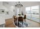 Bright dining area with a round table, modern lighting, and access to an outdoor balcony at 4511 Tabor St, Wheat Ridge, CO 80033