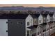Modern townhome exterior with gray and white siding and mountain views in the background at 4511 Tabor St, Wheat Ridge, CO 80033