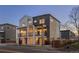 Modern two-story townhome showcasing a stylish exterior with balconies and coordinated color scheme at 4511 Tabor St, Wheat Ridge, CO 80033