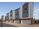 Modern townhome exterior with garages and combination of gray and white siding at 4511 Tabor St, Wheat Ridge, CO 80033