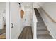 Hallway with stairs to the second floor, hardwood floors, and a sliding barn door at 4511 Tabor St, Wheat Ridge, CO 80033