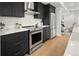 Modern kitchen with stainless steel appliances, white subway tile backsplash, and black cabinetry at 4511 Tabor St, Wheat Ridge, CO 80033