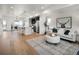 Open-concept living and kitchen area with hardwood floors, pendant lighting, and modern decor at 4511 Tabor St, Wheat Ridge, CO 80033