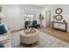 Bright living room featuring hardwood floors, accent furniture, an ottoman and decor at 4511 Tabor St, Wheat Ridge, CO 80033