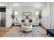 Stylishly designed living room with accent chairs, modern decor, and a contemporary area rug at 4511 Tabor St, Wheat Ridge, CO 80033