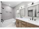 Bathroom featuring dual sinks, modern fixtures, and a shower-tub combo at 1306 Yates St, Denver, CO 80204