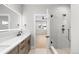Bright bathroom with a spacious vanity, modern fixtures, and glass-enclosed shower at 1306 Yates St, Denver, CO 80204