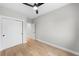 Neutral bedroom with hardwood floors, closet, ceiling fan, and white trim at 1306 Yates St, Denver, CO 80204