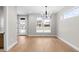 Bright dining room with hardwood floors, modern chandelier, and large window overlooking the neighborhood at 1306 Yates St, Denver, CO 80204