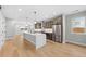 Open-concept kitchen with stainless steel appliances, an island, and a seamless flow to the rest of the home at 1306 Yates St, Denver, CO 80204