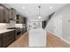 Spacious kitchen featuring island with seating, wood floors, and stainless steel appliances at 1306 Yates St, Denver, CO 80204