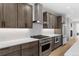 Close-up of kitchen with stainless steel range and hood, subway tile backsplash, and sleek cabinetry at 1306 Yates St, Denver, CO 80204