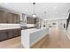 Bright, open kitchen featuring wood floors, a large island, stainless steel appliances, and access to living spaces at 1306 Yates St, Denver, CO 80204