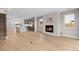 Open-concept space with fireplace, kitchen with island, hardwood floors, and modern design at 1306 Yates St, Denver, CO 80204