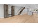 Open-concept living area with hardwood floors, staircase, mudroom, and bright, modern lighting at 1306 Yates St, Denver, CO 80204