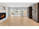 Bright living room featuring hardwood floors, a modern fireplace, and sliding glass doors to the outside at 1306 Yates St, Denver, CO 80204