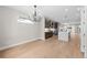Open layout with wood floors and chandelier, connecting dining area, kitchen, and additional living spaces at 1306 Yates St, Denver, CO 80204