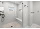 Modern bathroom shower featuring gray tile, glass enclosure, and a built-in bench at 1306 Yates St, Denver, CO 80204