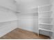 Bright walk-in closet featuring a built-in shelving system and hardwood floors at 1306 Yates St, Denver, CO 80204