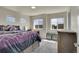 Spacious bedroom with plush carpeting and large windows offering natural light at 1651 Aspen Meadows Cir, Denver, CO 80260