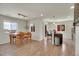 Open concept dining area adjacent to kitchen island with modern bar stools and wood flooring at 1651 Aspen Meadows Cir, Denver, CO 80260