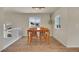 Bright dining area with wood floors, light-colored walls, and modern lighting fixtures at 1651 Aspen Meadows Cir, Denver, CO 80260