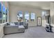 Comfortable living room featuring a sectional sofa, bright windows, and plush carpeting at 1651 Aspen Meadows Cir, Denver, CO 80260
