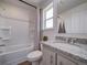 Bright bathroom with granite countertops, a shower-tub combo, and modern fixtures at 13079 E 103Rd Pl, Commerce City, CO 80022