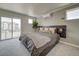 Serene bedroom with a plush bed, balcony access, and views of the neighborhood at 13079 E 103Rd Pl, Commerce City, CO 80022