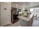 Modern kitchen with gray cabinets, granite countertops, and stainless steel appliances at 13079 E 103Rd Pl, Commerce City, CO 80022