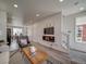 Bright living room featuring modern decor, fireplace, and hardwood floors at 13079 E 103Rd Pl, Commerce City, CO 80022