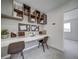 Modern office space featuring sleek floating desk, stylish floating shelves, and neutral tones at 13079 E 103Rd Pl, Commerce City, CO 80022