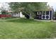 Well-maintained backyard featuring a neat lawn, mature tree, and charming storage shed at 5095 Grant St, Denver, CO 80216
