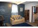 Cozy basement living area featuring a comfortable sofa, textured walls, and decorative touches at 5095 Grant St, Denver, CO 80216