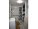 A well-lit bathroom with a built-in laundry nook and accessible shower at 5095 Grant St, Denver, CO 80216