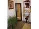 The bathroom is furnished with tiled floors, vanity storage, a decorative mirror and plant at 5095 Grant St, Denver, CO 80216